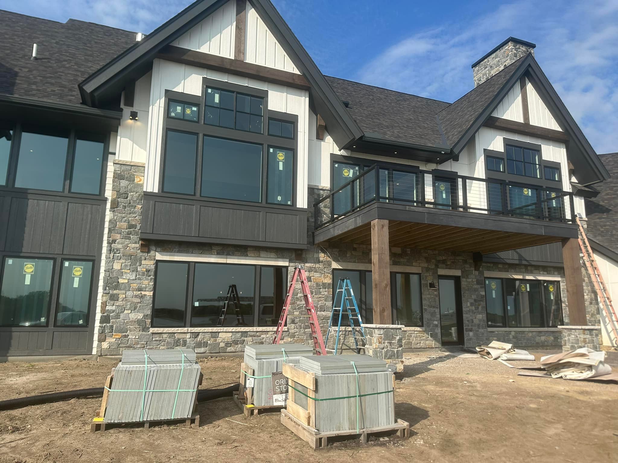 Stone veneer across the lower exterior and columns of a house under construction
