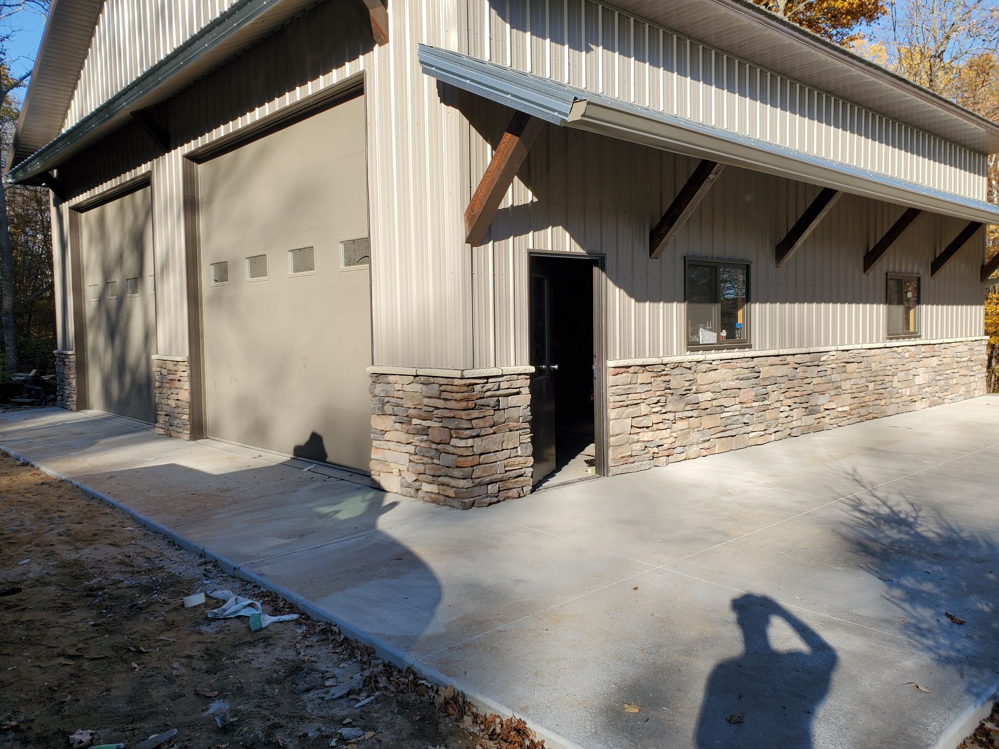 Stone veneer base and columns around the exterior of a large outbuilding